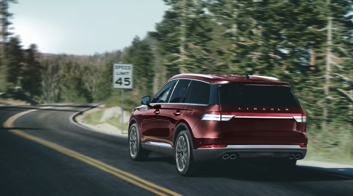 A 2024 Lincoln Aviator® SUV is being driven on a winding mountain road | Stivers Lincoln (AL) in Montgomery AL