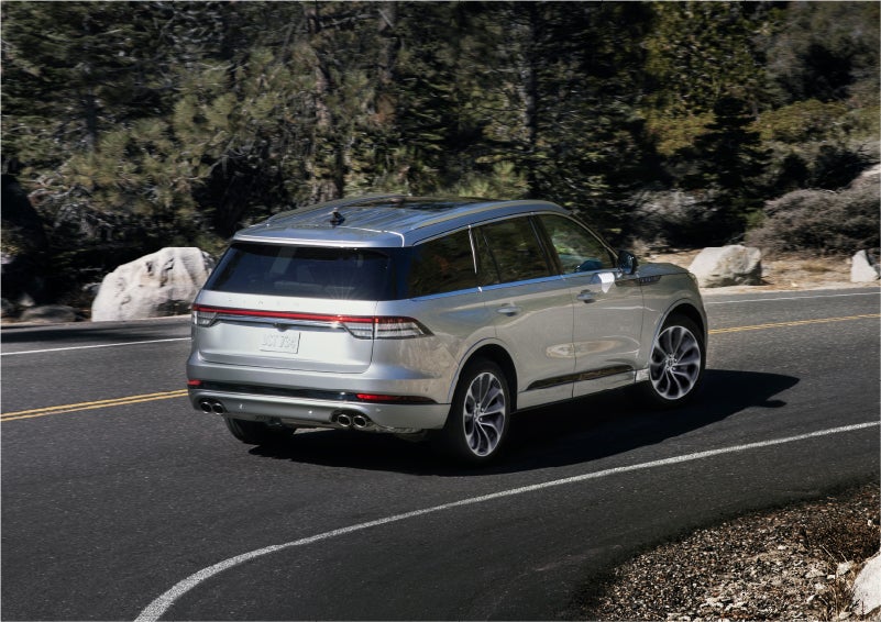 A 2023 Lincoln Aviator® Grand Touring model is shown being driven on a tight turn of a mountain road | Stivers Lincoln (AL) in Montgomery AL