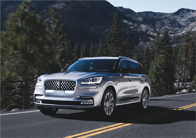 A 2023 Lincoln Aviator® Grand Touring SUV being driven on a winding road to demonstrate the capabilities of all-wheel drive | Stivers Lincoln (AL) in Montgomery AL