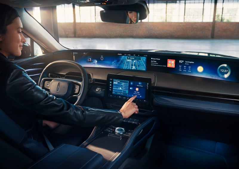 The driver of a 2024 Lincoln Nautilus® SUV interacts with the center touchscreen. | Stivers Lincoln (AL) in Montgomery AL