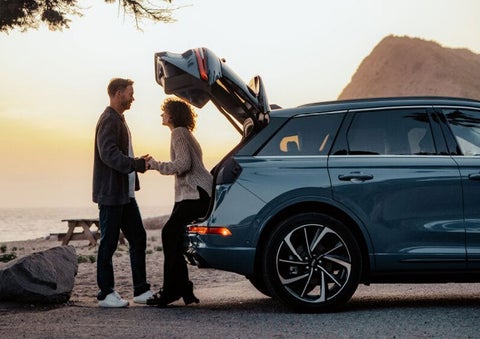A couple share a moment together outside a 2025 Lincoln Corsair® SUV near the open liftgate. | Stivers Lincoln (AL) in Montgomery AL