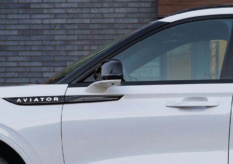 The driver’s side door and fender badging of a white 2026 Lincoln Aviator® SUV are showcased. | Stivers Lincoln (AL) in Montgomery AL