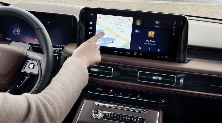 A person is tapping the center display touchscreen of a 2026 Lincoln Aviator® SUV. | Stivers Lincoln (AL) in Montgomery AL