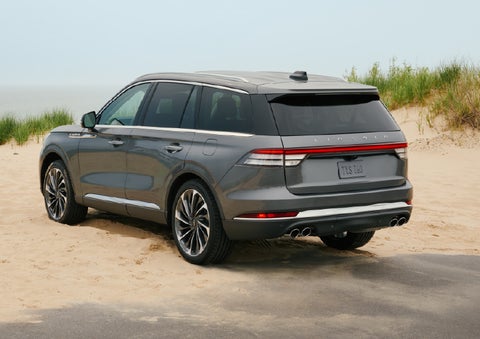 A 2027 Lincoln Aviator® SUV is parked next to sand dunes. | Stivers Lincoln (AL) in Montgomery AL