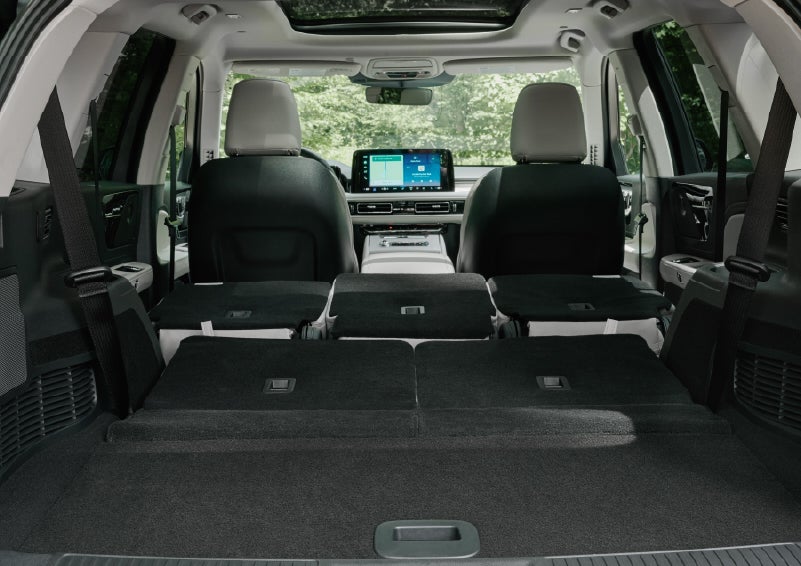 A rear to front view of the interior of a 2027 Lincoln Aviator® Black Label™ SUV shows the third and second rows folded flat | Stivers Lincoln (AL) in Montgomery AL