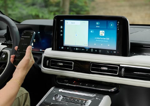 A person pairs thier phone with the center touchscreen of a 2027 Lincoln Aviator® Black Label™ SUV | Stivers Lincoln (AL) in Montgomery AL