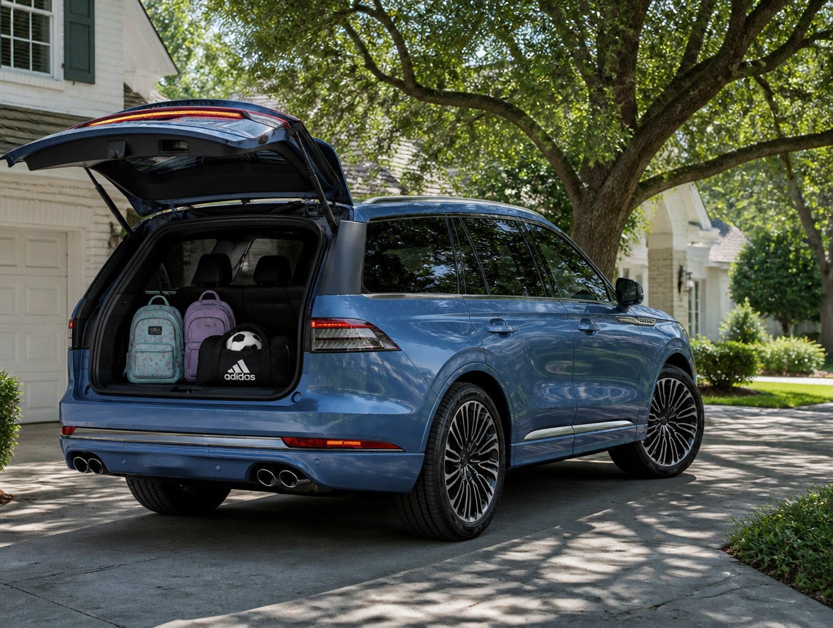 2026 Lincoln Aviator rear liftgate open with school bags in an east Montgomery driveway under live oaks